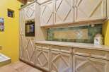 This charming kitchen boasts custom cabinetry and a built-in oven, perfect for culinary enthusiasts.