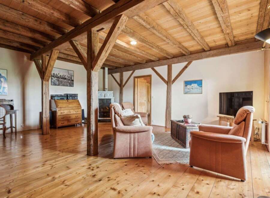 Step into a world of rustic charm with this stunning property, featuring exposed wooden beams and a warm, inviting atmosphere.