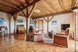 Step into a world of rustic charm with this stunning property, featuring exposed wooden beams and a warm, inviting atmosphere.
