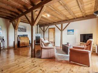 Step into a world of rustic charm with this stunning property, featuring exposed wooden beams and a warm, inviting atmosphere.