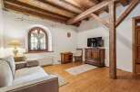 Discover the charm of this rustic living space, featuring exposed wooden beams and a cozy ambiance.