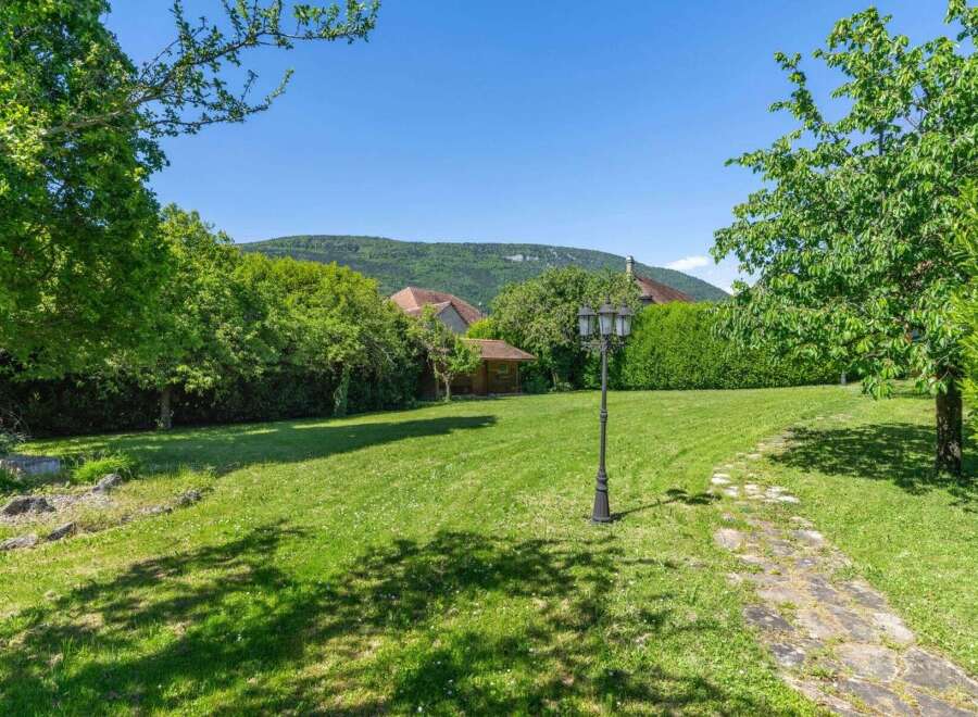 Discover the charm of this stunning property, featuring a lush green lawn perfect for outdoor activities.