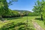 Discover the charm of this stunning property, featuring a lush green lawn perfect for outdoor activities.