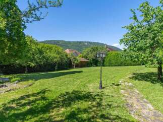 Discover the charm of this stunning property, featuring a lush green lawn perfect for outdoor activities.