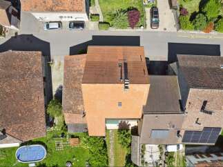 Discover this charming property featuring a classic red-tiled roof and a well-maintained exterior.