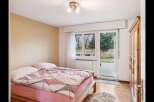 This cozy bedroom features a comfortable bed with stylish bedding and a soft rug.
