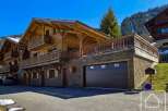 Discover a stunning chalet nestled in a picturesque mountain setting.