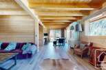 Experience the epitome of alpine living in this stunning property, boasting a warm and inviting interior with exposed wooden beams and paneling.