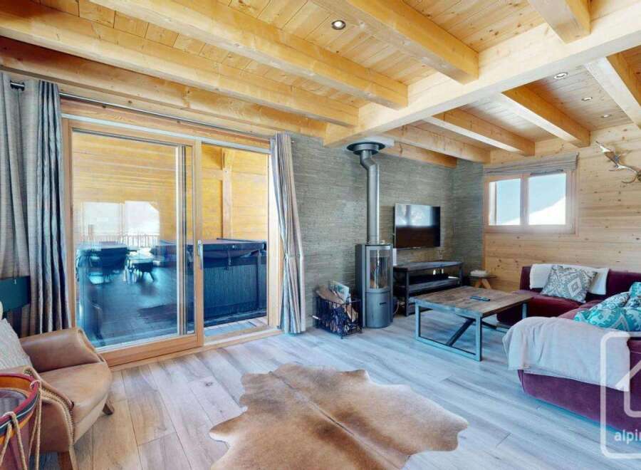Experience luxury living in this stunning property, featuring a cozy living room with a fireplace and a comfortable sofa.