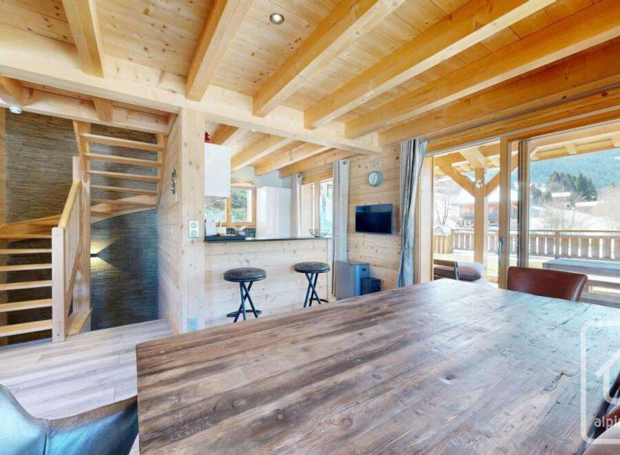 Experience the charm of this stunning property, featuring a beautifully designed interior with wooden accents and a cozy atmosphere.