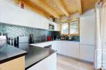 This stunning kitchen boasts modern design with sleek white cabinetry and a striking backsplash.