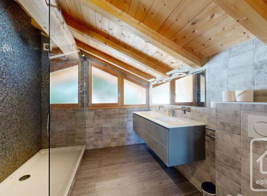 Experience luxury in this stunning bathroom, featuring a modern floating vanity and sleek fixtures.