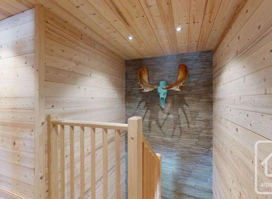 This stunning property features a beautifully designed staircase with wooden paneling, creating a warm and inviting atmosphere.