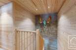 This stunning property features a beautifully designed staircase with wooden paneling, creating a warm and inviting atmosphere.
