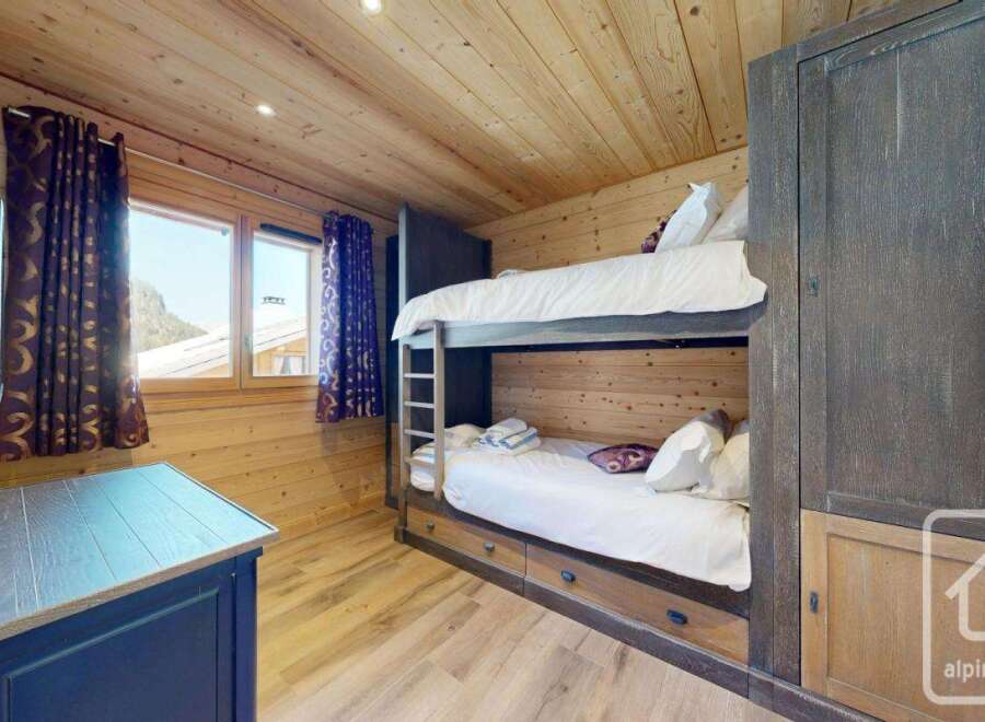 Discover the charm of this cozy bedroom featuring a bunk bed, perfect for accommodating guests or family.