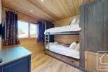 Discover the charm of this cozy bedroom featuring a bunk bed, perfect for accommodating guests or family.