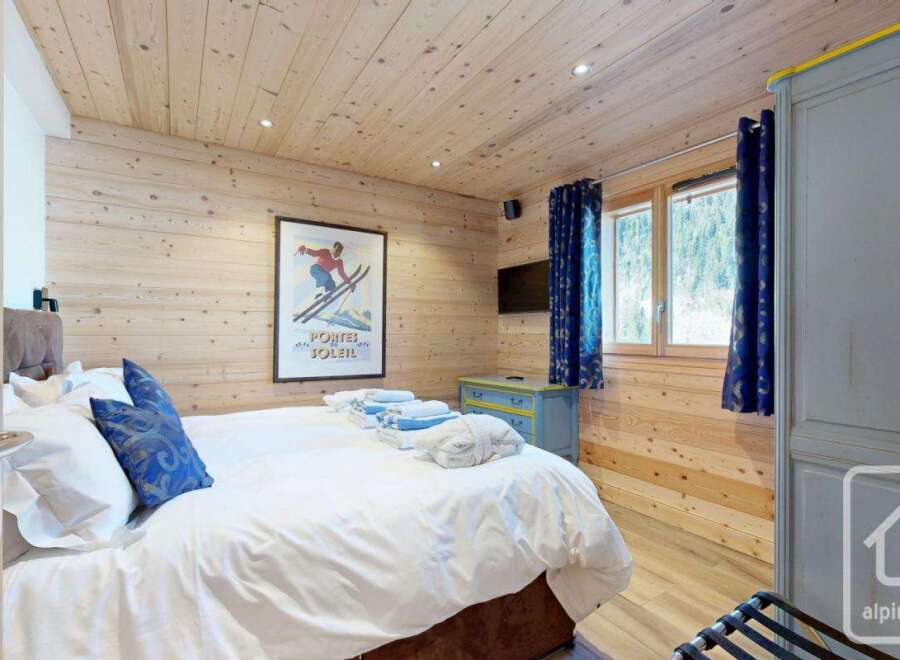 This cozy bedroom features a warm wooden interior, creating a welcoming atmosphere.