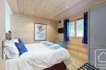 This cozy bedroom features a warm wooden interior, creating a welcoming atmosphere.