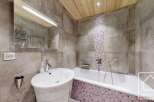 This modern bathroom features a sleek design with a combination of wood and tile.