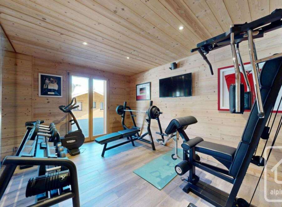 This stunning home gym boasts a modern design with high-quality equipment.