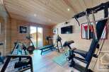This stunning home gym boasts a modern design with high-quality equipment.