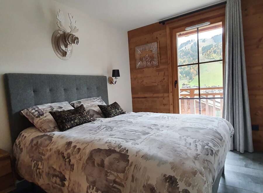 Experience the charm of this cozy bedroom, featuring a comfortable bed with stylish bedding and decorative pillows.