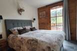 Experience the charm of this cozy bedroom, featuring a comfortable bed with stylish bedding and decorative pillows.
