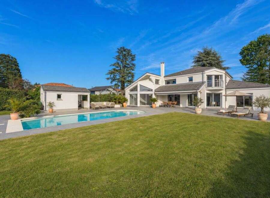 Discover luxury living in this stunning property featuring a private pool and expansive green lawn, perfect for outdoor enjoyment.