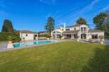 Discover luxury living in this stunning property featuring a private pool and expansive green lawn, perfect for outdoor enjoyment.