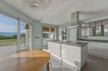 This stunning kitchen boasts modern design and seamless indoor-outdoor living.