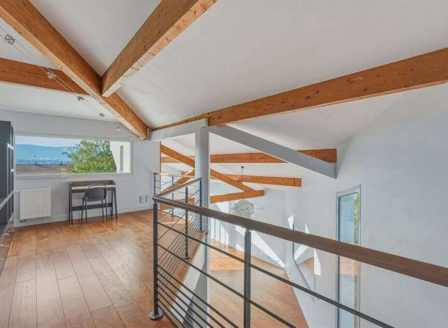 This stunning property boasts a unique architectural design with exposed wooden beams and a bright, airy interior.