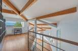 This stunning property boasts a unique architectural design with exposed wooden beams and a bright, airy interior.