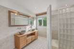 This stunning bathroom boasts a modern design with a touch of natural elements.