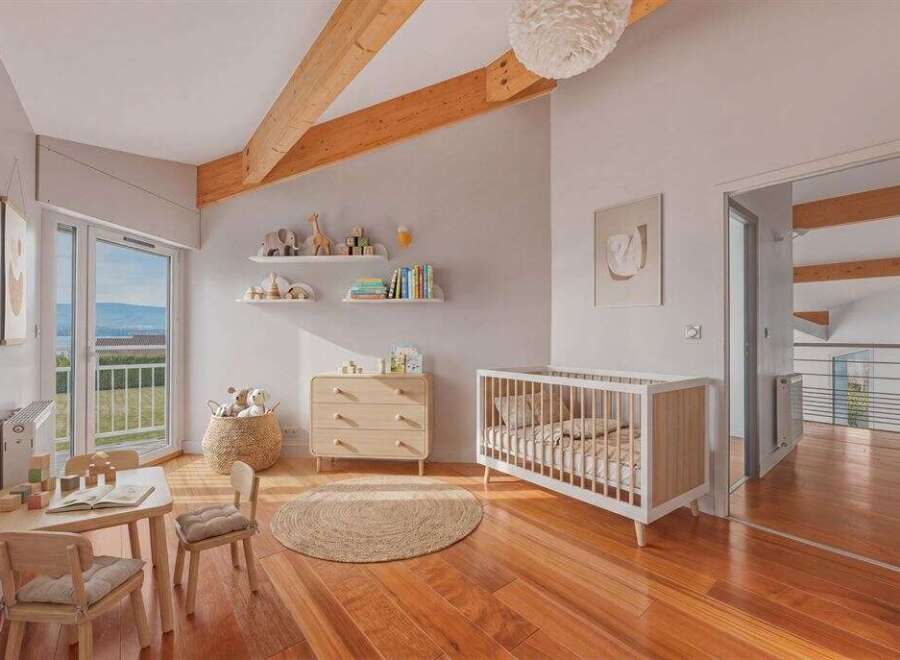 This charming nursery features a bright and airy design with natural wood flooring and exposed beams.