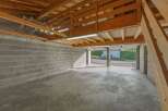 Discover the potential of this spacious garage, perfect for storage or a workshop.