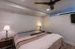 This cozy bedroom features a comfortable bed with a stylish quilt, perfect for a relaxing night's sleep.