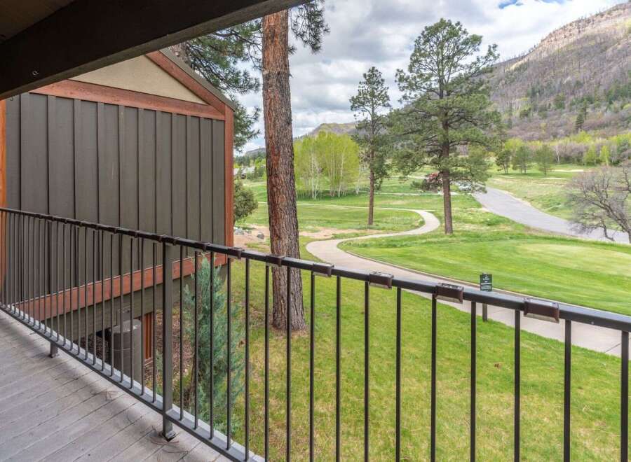Enjoy breathtaking views from this stunning property! This home features a private balcony overlooking a lush green golf course and scenic mountain views.