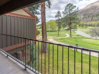 Enjoy breathtaking views from this stunning property! This home features a private balcony overlooking a lush green golf course and scenic mountain views.