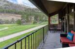 Enjoy breathtaking views from this stunning property! This home features a spacious deck overlooking a lush green golf course and majestic mountains.