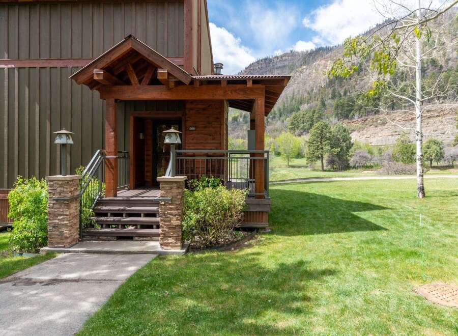 This stunning property boasts a charming exterior with a welcoming porch and a beautifully landscaped yard.