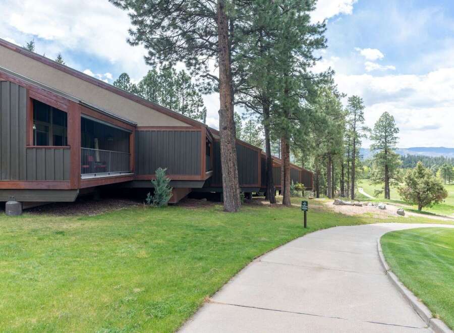 Discover a stunning property with a unique architectural design, nestled amidst lush greenery and mature trees.