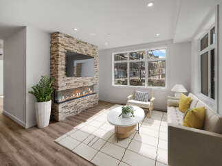 Experience luxury living in this stunning property featuring a modern fireplace and a sleek TV setup.
