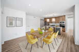 This stunning property features a modern dining area with a wooden table and stylish yellow chairs.