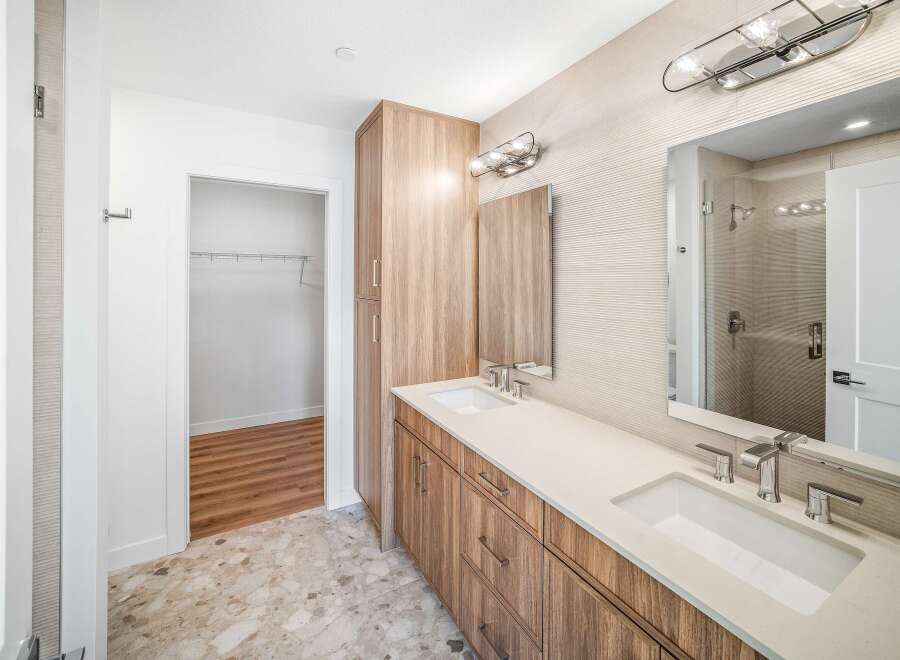 Step into luxury with this stunning bathroom featuring a sleek double vanity and modern fixtures.