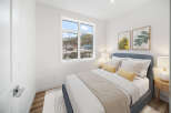This cozy bedroom offers a serene retreat with its inviting ambiance and stylish decor.
