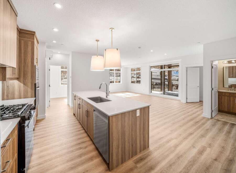 This stunning kitchen boasts a modern design with sleek cabinetry and a spacious island, perfect for culinary enthusiasts.