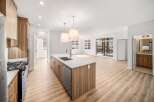 This stunning kitchen boasts a modern design with sleek cabinetry and a spacious island, perfect for culinary enthusiasts.