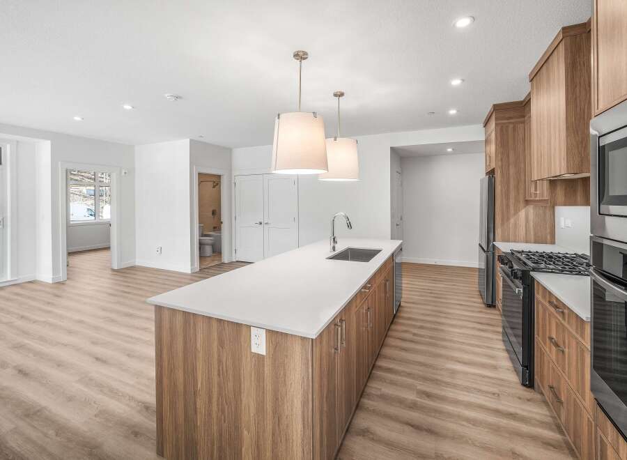 This stunning kitchen boasts a modern design with sleek cabinetry and a spacious island, perfect for both cooking and entertaining.