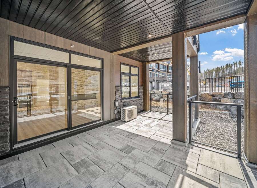 Step into luxury with this stunning outdoor space! Featuring a modern design, this patio boasts a sleek, contemporary aesthetic with its stone flooring and stylish glass railings.