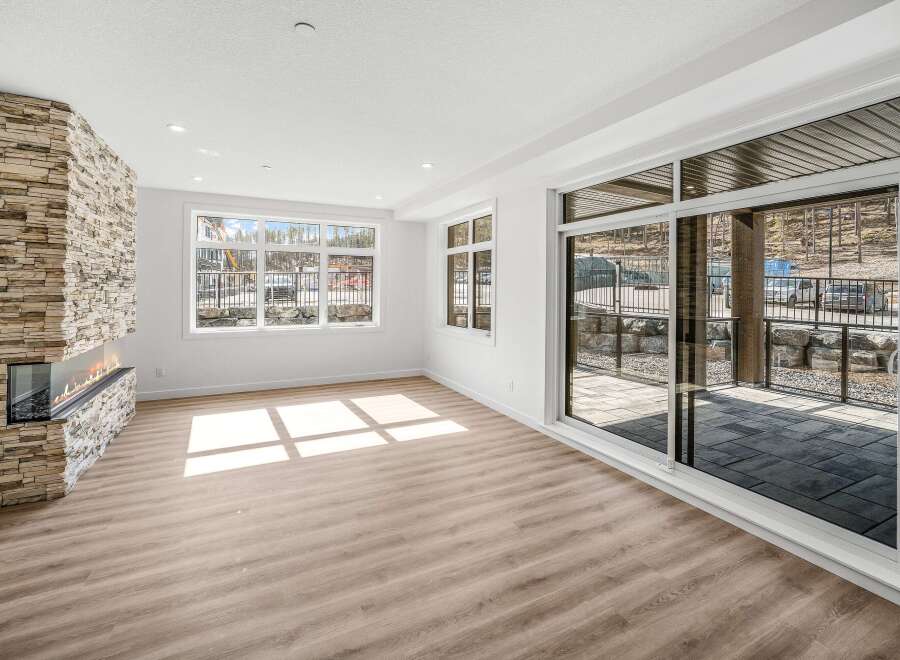Step into luxury with this stunning living space, featuring a modern fireplace and expansive windows that flood the room with natural light.